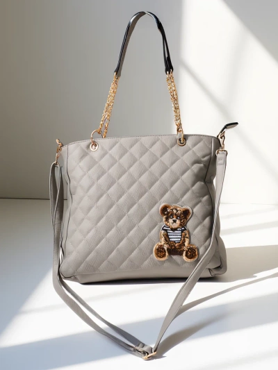 Royalfashion Gestepptes Damenhandtasche aus Eco-Leder mit einem Teddybär